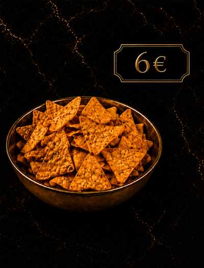 Knusprige Tortilla-Chips in einer goldenen Schale auf dunklem Hintergrund in der Lion Lounge Bar Offenbach